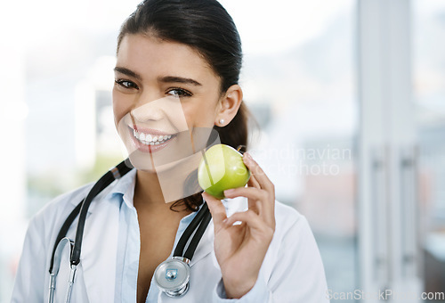 Image of Portrait, doctor and happy woman with apple for healthy diet, nutrition or wellness. Face, nutritionist or medical professional with fruit for vitamin c, healthcare or natural food for vegan benefits