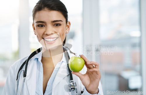 Image of Doctor, portrait and smile of woman with apple for nutrition, healthy diet or wellness. Face, nutritionist and medical professional with fruit for vitamin c, healthcare and food for vegan benefits.