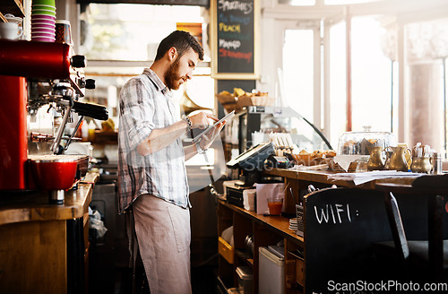 Image of Digital tablet, research and cafe owner working on a startup cafeteria business plan in a restaurant. Technology, entrepreneur and male barista or waiter checking stock on a mobile in his coffee shop