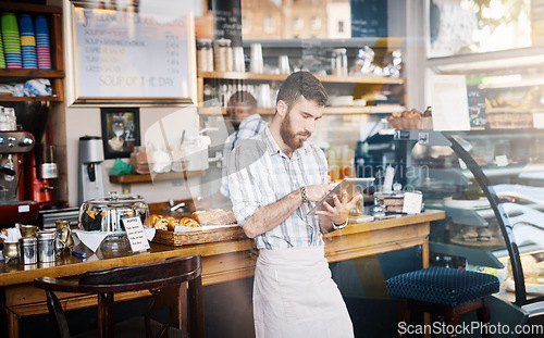 Image of Tablet, small business and barista doing inventory while working on startup plan in restaurant. Technology, entrepreneur and male cafe owner and waiter doing research on digital mobile in coffee shop