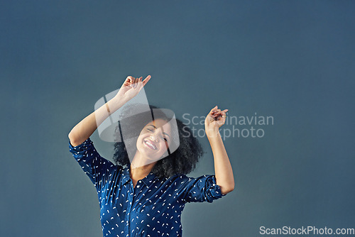 Image of Portrait, happy and pointing with a woman advertising in studio on a blue background for branding. Smile, silly and hand gesture with a female brand ambassador showing blank or empty marketing space