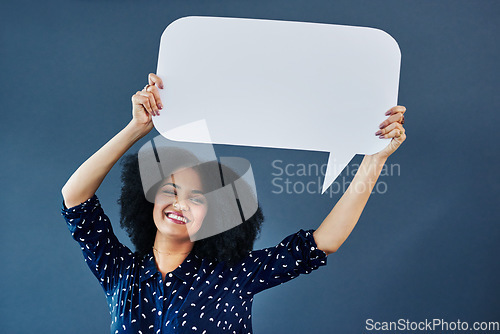 Image of Portrait, speech bubble and woman in studio with banner, news or announcement on blue background. Mockup, poster and happy female face with billboard for social media, advertising or branding launch