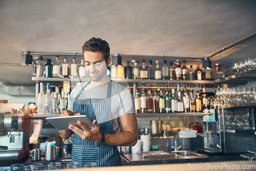 Image of Man in restaurant, tablet and small business with inventory check, entrepreneur in hospitality industry and connectivity. Male owner, scroll and cafe franchise with digital admin and stock taking