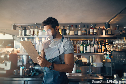 Image of Man in restaurant, checklist on clipboard and inventory check, small business and entrepreneur in hospitality industry. Male owner reading list, think and cafe franchise with admin and stock taking