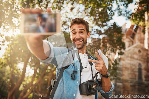 Image of Happy man, tourist and peace sign selfie in a city for travel with holiday memory, smile and happiness. Male person outdoor on adventure, journey or vacation photo and freedom with a backpack