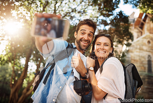 Image of Tourist couple, smile and selfie outdoor for travel in a city for vacation memory or happiness. Happy man and woman take picture on adventure, social media or holiday trip with freedom, love and care
