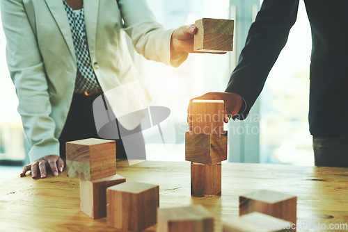 Image of Teamwork, man and woman in office with building blocks, design ideas and problem solving challenge. Engineering, planning and strategy, wood block game and team of business people working together.