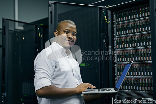 Image of Server room, black man or portrait of technician with laptop for online cyber security glitch or software. IT support, happy or friendly African engineer fixing network for information technology