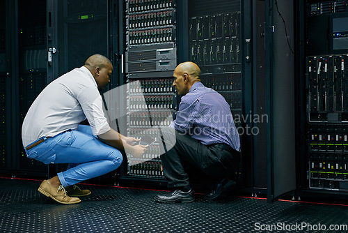 Image of Server room, men or technicians talking about hardware together for a cybersecurity glitch with teamwork. IT support, collaboration or African engineers fixing network for information technology