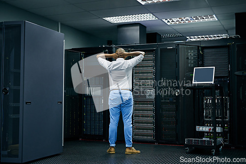 Image of Server room, IT support or electrician with a hardware problem stressed with maintenance or glitch crisis. Confused or back of worried technician or electrical engineers in information technology