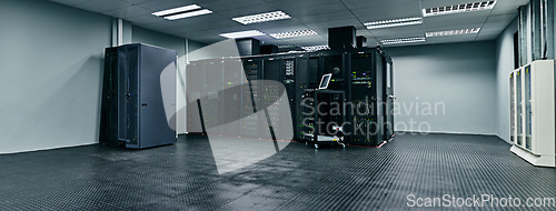 Image of Server room, empty or data center for internet connection, computing network or cyber security hardware. IT support background, information technology or machine equipment with laptop in a datacenter