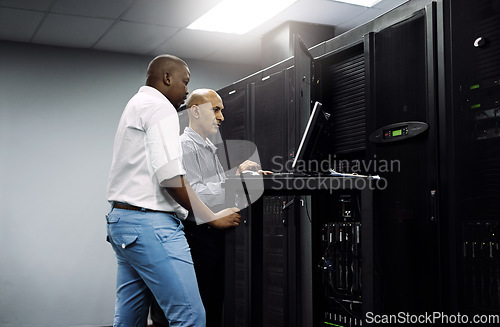 Image of Server room, people or technician coding on computer together for a cybersecurity glitch with teamwork. IT support code, collaboration or engineers fixing laptop network for information technology