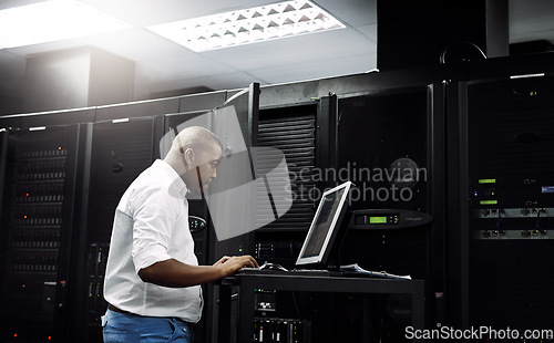 Image of Server room, black man or coding on computer for programming or digital error in data center. Cybersecurity, support or technician typing online for fixing, troubleshooting or software development