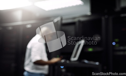 Image of Code, black man or coding on computer in server room for big data, tech glitch or digital website. IT support, blurry or technician typing on laptop testing UX, programming or software development