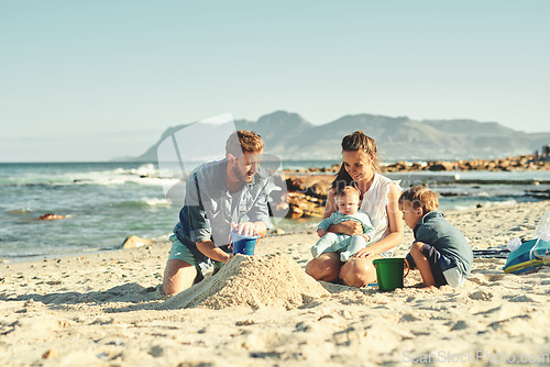 Image of Sandcastle building, parents and children at beach with bonding, love and support. Baby, mom and dad together with kids playing in the sun with mockup space and smile by the ocean and sea with family