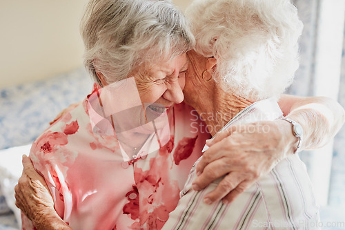 Image of Happy, hug and senior woman friends laughing in the bedroom of a retirement home together. Smile, reunion and laughter with an elderly female pensioner and friend bonding indoor during a visit