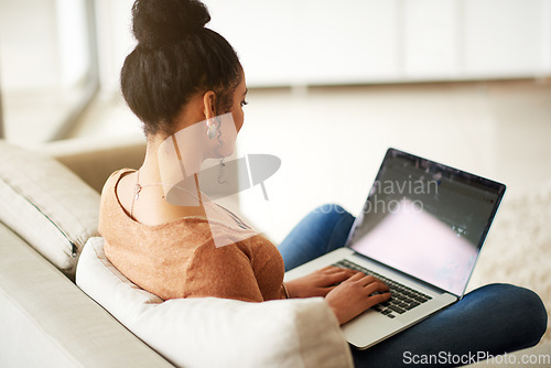 Image of Woman on couch with laptop, typing for blog and freelance copywriter working from home. Female freelancer in living room, copywriting and writing on pc, technology and remote work with connectivity