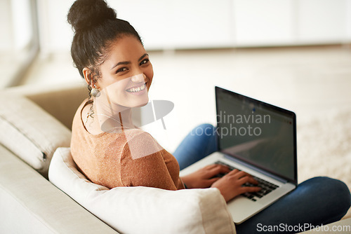 Image of Happy woman in portrait, couch and laptop, typing for blog and freelance copywriter working from home. Female freelancer in living room, copywriting and writing on pc with technology and remote work