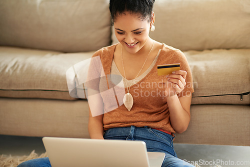 Image of Woman in living room, laptop and credit card with online shopping and payment on store website with fintech. Female person at home, smile and happy with internet banking, finance and e commerce