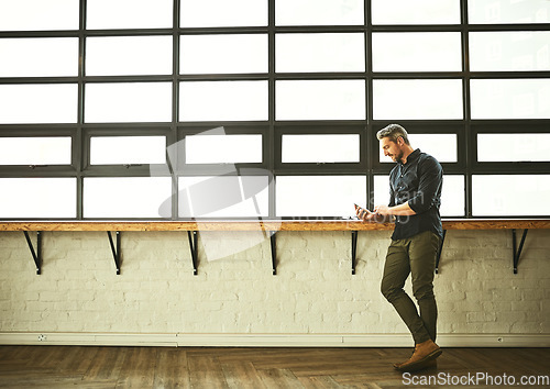 Image of Phone, typing and man at office window with mockup, creative startup and project for entrepreneur at design agency. Networking, space and internet, businessman with online connectivity on smartphone.