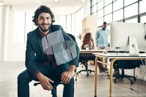 Image of Portrait, startup and office, happy man in chair and creative business project for entrepreneur at design agency. Boss, smile and happiness, successful young businessman or ceo in start up workspace