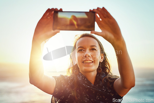 Image of Selfie, nature and woman with smart phone or enjoying ocean or relaxed face for vacation in summer or excited on bokeh. Face, female person and taking picture or holiday fun or blue sky and sea