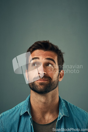 Image of Man, face and thinking on mockup space for idea, plan or wondering against a grey studio background. Isolated thoughtful male person or model in question, doubt or confused mindset for planning dream