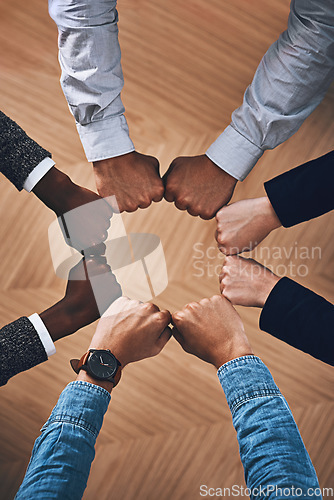 Image of Team building, fist bump or hands of business people for support, diversity or community group in office. Teamwork, above or circle of fists for motivation, collaboration or partnership for a mission