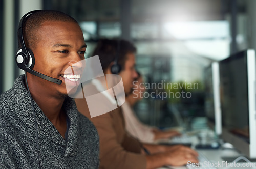 Image of Call center, customer service and male consultant in office doing online consultation. Communication, contact us and salesman or telemarketing agent working on crm strategy with headset in workplace.