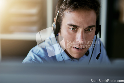 Image of Telemarketing agent, focus and man consulting with advice, sales or help desk worker with headset. Phone call, conversation and customer support consultant, crm service agency listening on headphones