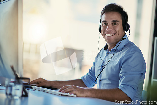 Image of Portrait of callcenter agent, smile and man consulting with advice, crm and happiness at help desk. Phone call service, conversation and happy customer support consultant working in modern office.