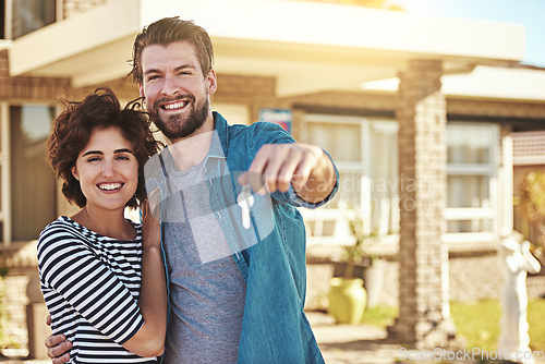 Image of Keys, new home and portrait of a couple outdoor at a real estate property with pride for buying a house. Happy woman and a excited man moving in together with mortgage and housing loan goal or dream