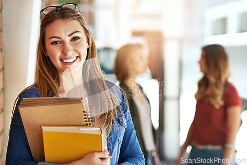 Image of Portrait, books and flare with a student woman on campus at university for education or learning. Smile, study and college with a happy young female pupil in school for an academic scholarship