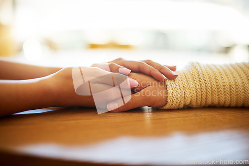 Image of Caring, closeup of women holding hands on table and for support or comfort. Cancer or compassion, gratitude or kindness and female friends touching helping hand together for love or empathy.