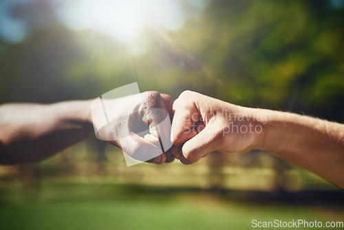 Image of Hands, fist bump and men in a park with support, solidarity and collaboration on blurred background. Hello, hand and friends greeting outdoor with thank you emoji, sign or respect gesture of unity