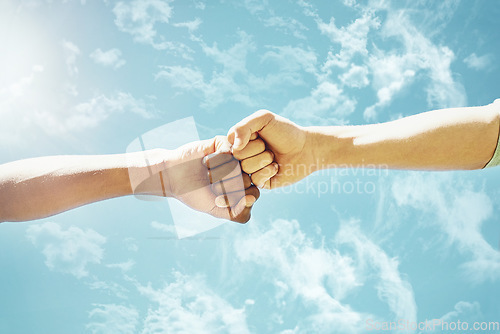 Image of Fist bump, people and blue sky with motivation, success and teamwork outdoor. Support, friends and winning hand sign in summer with celebration and agreement showing solidarity in nature from victory