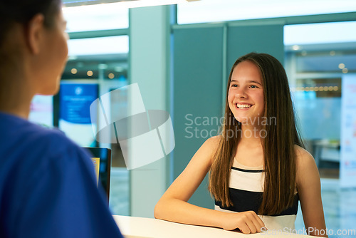 Image of Help, reception and nurse with patient in hospital for advice, medical and information. Medicine, happy and healthcare with teenage girl at desk in clinic for nursing, waiting room and service
