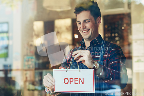 Image of Open sign, cafe and man with business, startup and poster with service, board and franchise window. Male person, happy employee and entrepreneur with a waiter, new and opening store with hospitality