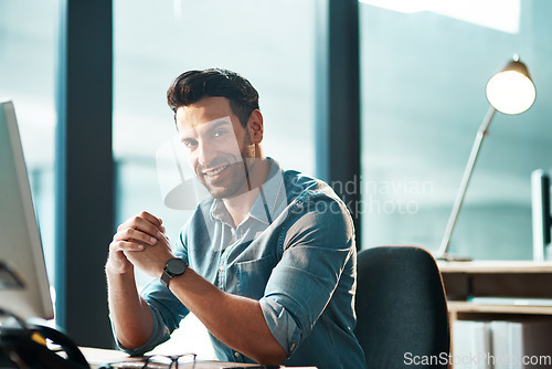 Image of Business man, portrait and smile at desk in office with confidence, happiness and commitment to company. Happy male entrepreneur at computer in startup agency with pride, professional and motivation