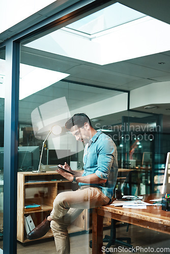 Image of Business man, tablet and focused in office for planning, data update and internet research at night. Serious male employee, digital technology and strategy for online information, insight and iot app