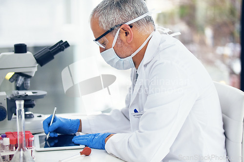 Image of Science, tablet and scientist writing results of a vaccine in after medical exam in a lab or laboratory. Medicine, research and healthcare man or chemistry professional with solution for covid
