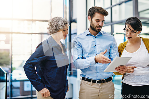 Image of Business people, tablet and meeting for idea, collaboration or planning together at the office. Group of employee workers working on technology in teamwork for research, project plan or networking