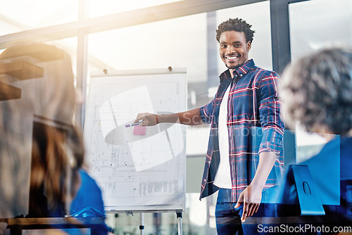 Image of Business meeting, presentation and happy black man with team in office for growth, development and sale target. Speaker, black man and leader with whiteboard and people for planning, goal or strategy