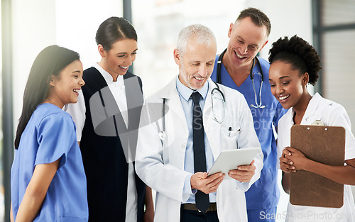 Image of Digital tablet, team and group of healthcare workers in discussion on xrays in medicare clinic. Collaboration, diversity and professional medical employees analyzing a diagnosis on mobile in hospital