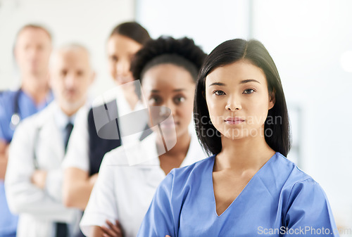 Image of Teamwork, portrait of doctors and nurses in hospital, support and team work in healthcare. Health, diversity and medicine, serious woman doctor and group of medical employees standing in row together