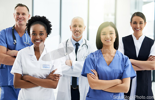 Image of Confidence, crossed arms and portrait of team of doctors standing in the hallway with collaboration. Happy, diversity and group of healthcare workers in the corridor of a medical clinic or hospital.