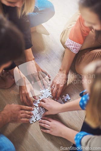 Image of Top view, people and hands with puzzle for teamwork, solution and problem solving for innovation. Closeup, team building and planning jigsaw for integration, collaboration and synergy for cooperation