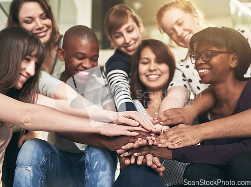 Image of Goal, motivation and friends with their hands in a huddle together for education, support or success. Teamwork, smile and trust with a happy group of students bonding at college or university