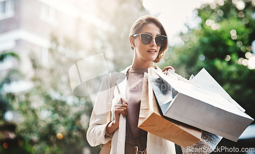 Image of Fashion, shopping bag or rich woman in city or street for boutique retail sale, or clothes discount deals. Sunglasses, financial freedom or trendy girl customer walking on road with luxury products