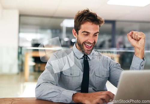 Image of Business man, fist and celebrate with laptop, winning and promotion at startup with excited face. Young businessman, winner and celebration with computer, bonus or profit with trading on stock market